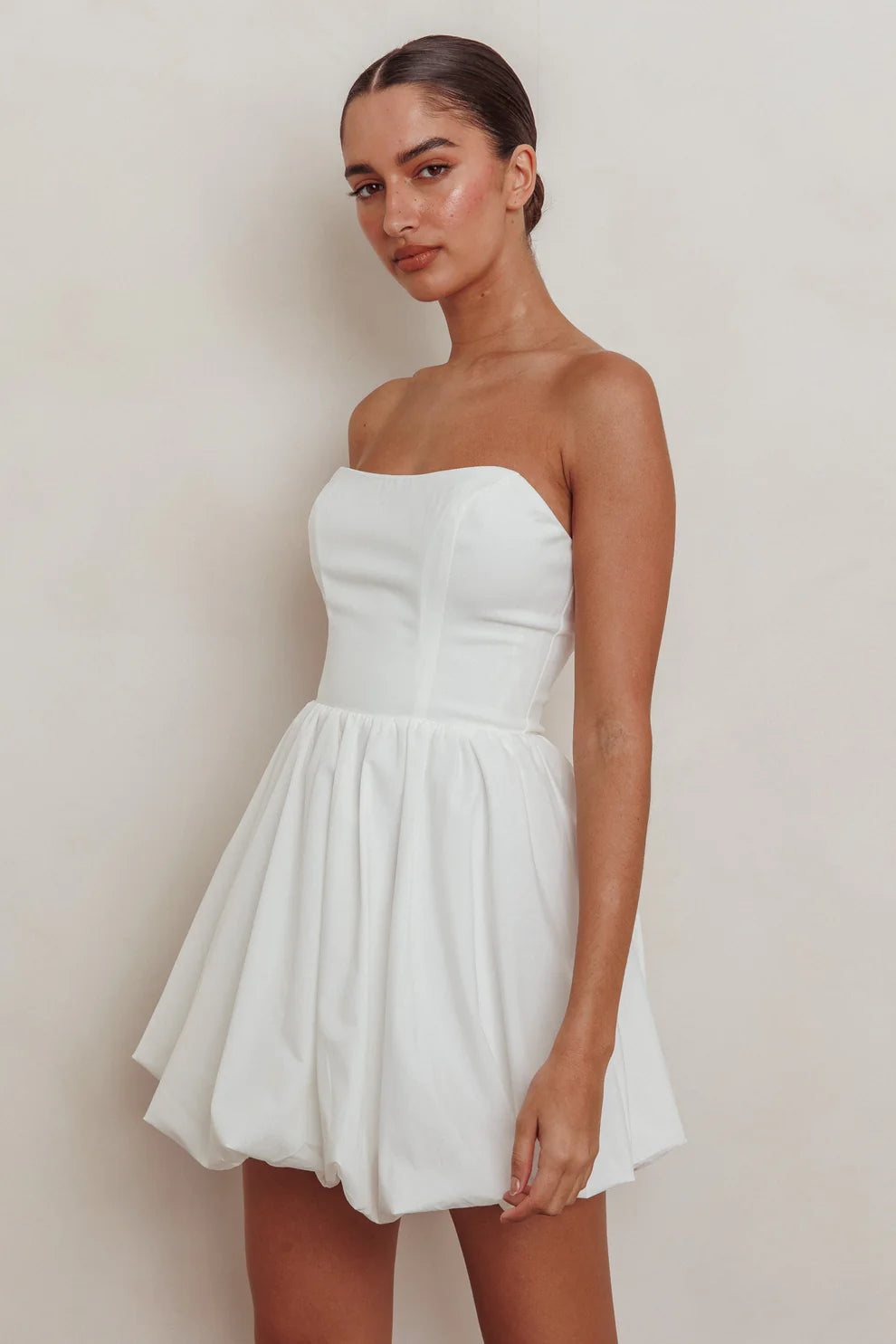 White strapless mini dress with bubble skirt and boned top