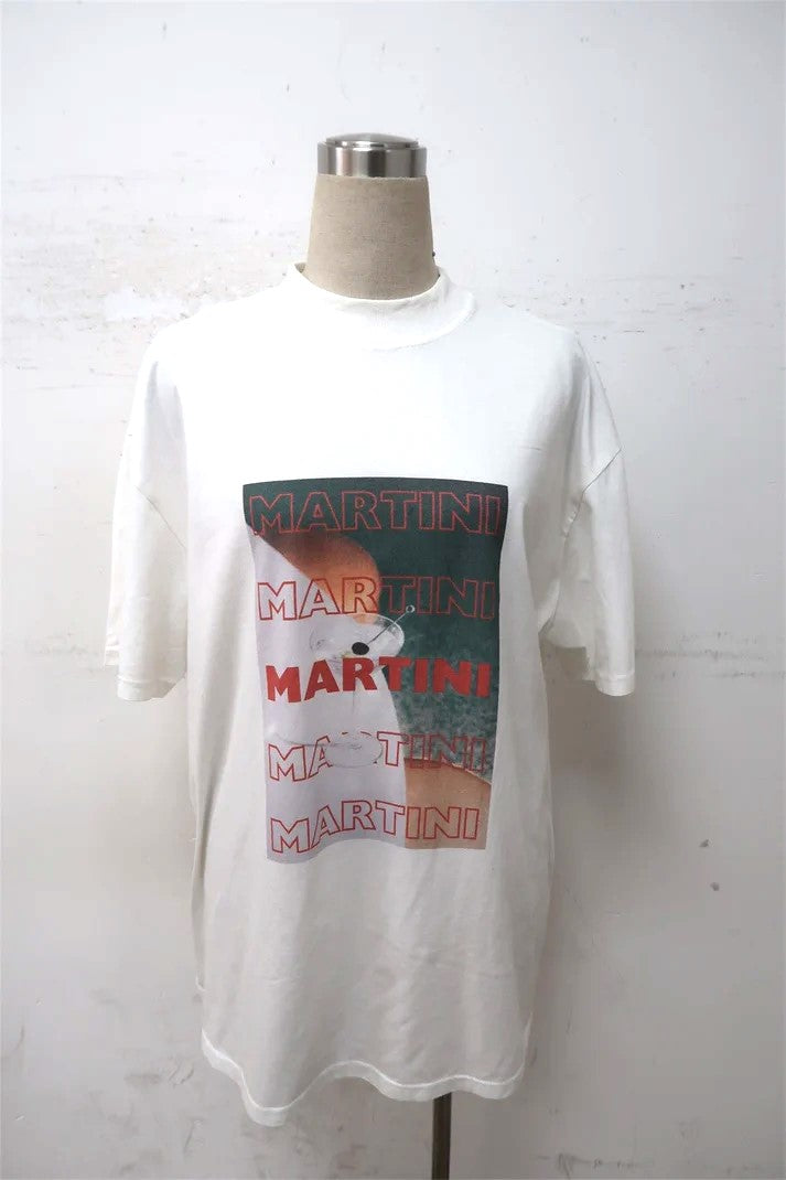 Front view of a soft cotton t-shirt in a white color, featuring a martini graphic design on the chest. The t-shirt has a crew neckline and short sleeves, perfect for casual wear oversized