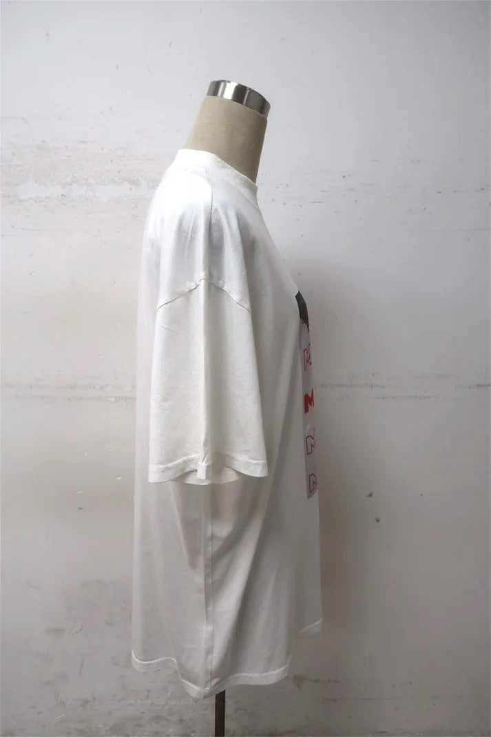 side view of a soft cotton t-shirt in a white color, featuring a martini graphic design on the chest. The t-shirt has a crew neckline and short sleeves, perfect for casual wear oversized