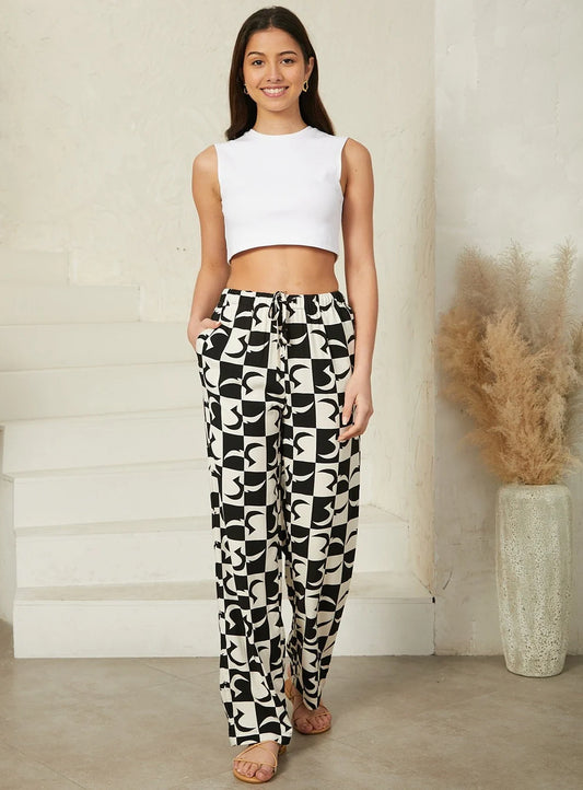 Geo print pants featuring a bold geometric design for a contemporary look with a drawstring waist, pockets. 