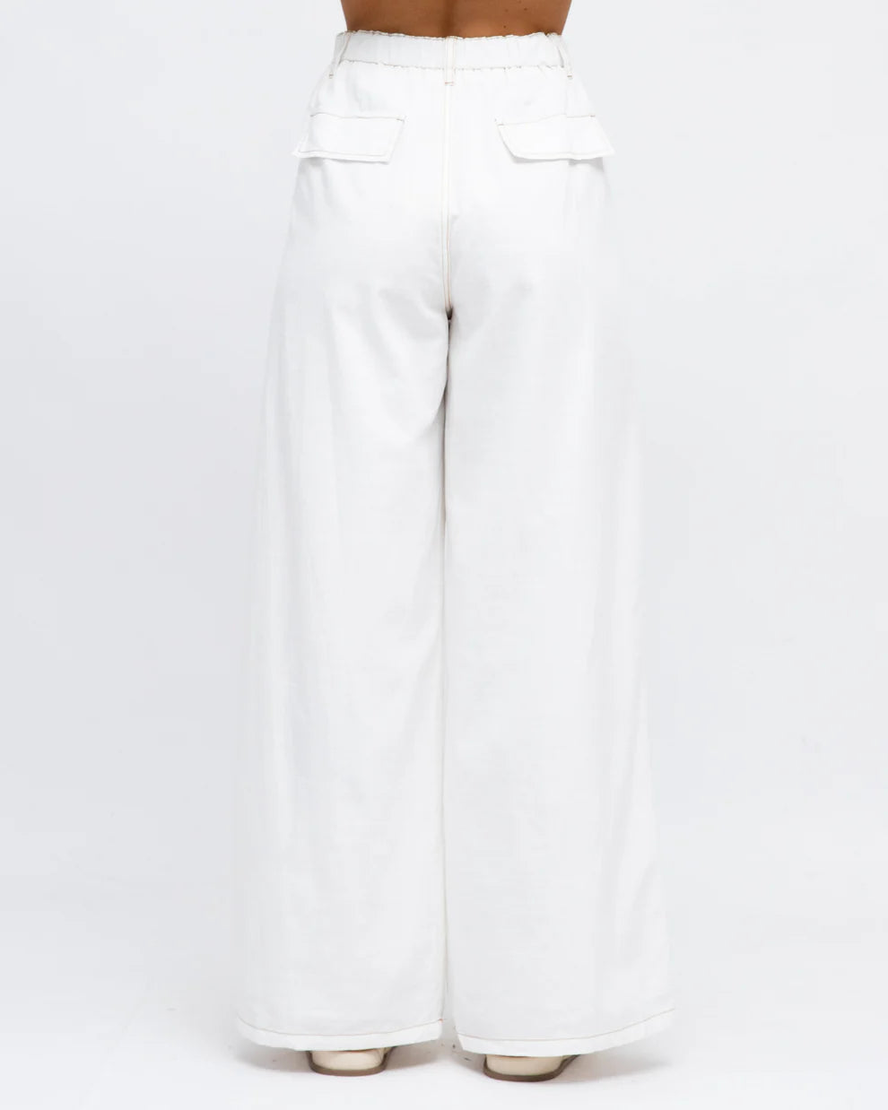 White cotton pants offering comfort and a relaxed fit for casual summer wear back view.